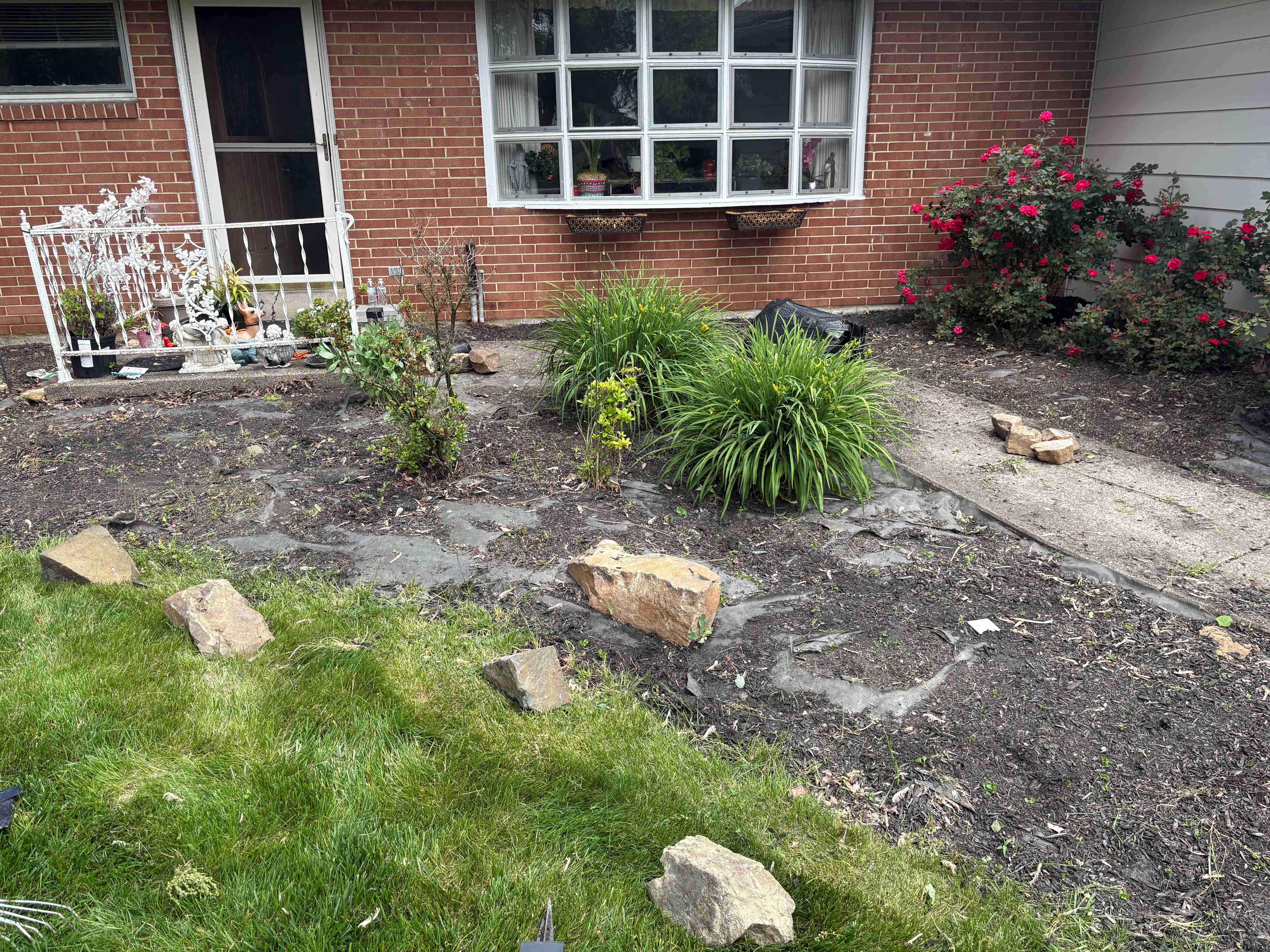 Before: Front beds cleared, edged, and finished with fresh dark mulch